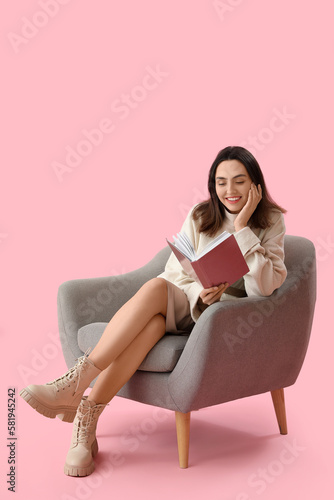 Young woman reading book in...