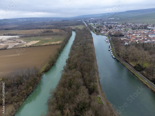 Aerial panoramic winter view on cloudy landscape, hilly vineyards and Marne river near Ay gran cru champagne village, wine production in France