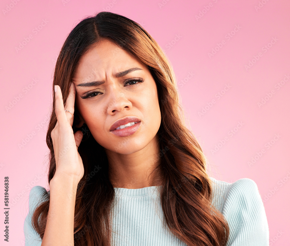 Stress, burnout and woman with headache in studio, tired or exhausted on pink background. Mental health, depression and anxiety, overworked hispanic model with hand on head in pain and temple massage Stress, burnout and woman with headache in studio, tired or exhausted on pink background. Mental health, depression and anxiety, overworked hispanic model with hand on head in pain and temple massage