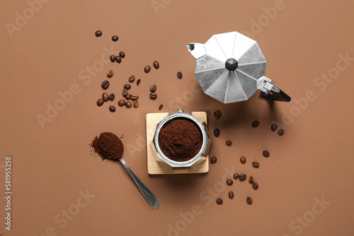 Coffee maker with powder and beans on brown background photo