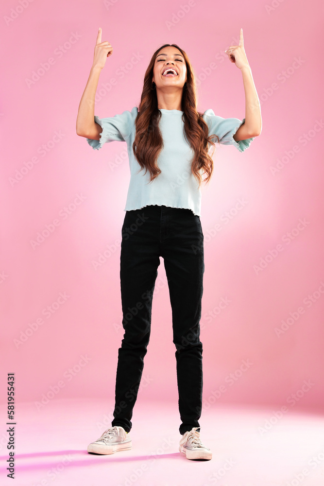 Pointing, mockup and woman in studio on pink background with happy, smile and excited for discount news. Advertising, hands and girl looking up for product placement, promotion and deal announcement Pointing, mockup and woman in studio on pink background with happy, smile and excited for discount news. Advertising, hands and girl looking up for product placement, promotion and deal announcement