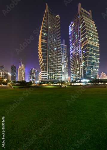 Jumeirah Lakes Towers, Dubai, United Arab Emirates - Dec.21, 2017: Complex - Armada Towers. Night View from the Glade to the Skyscrapers