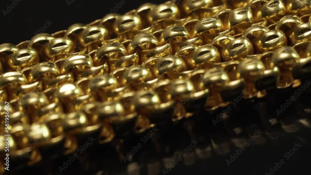 Closeup shot of gold necklaces with rotating
Closeup shot of gold necklaces with rotating