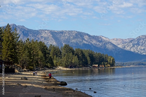 Parasailers and boaters begin their mornings on the peaceful waters of Lake Tahoe in the Sierra Nevada Mountains photo