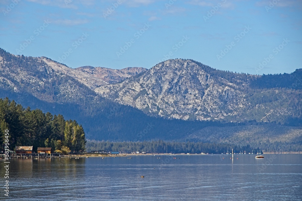 Parasailers and boaters begin their mornings on the peaceful waters of Lake Tahoe in the Sierra Nevada Mountains