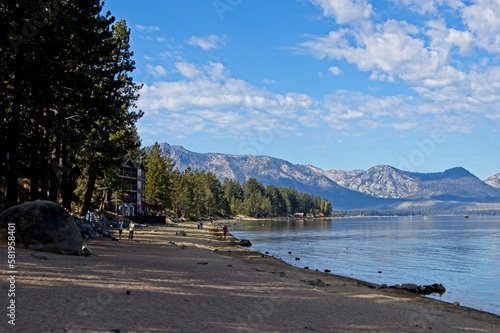 Parasailers and boaters begin their mornings on the peaceful waters of Lake Tahoe in the Sierra Nevada Mountains