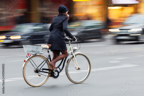 woman riding a bicycle on a city street