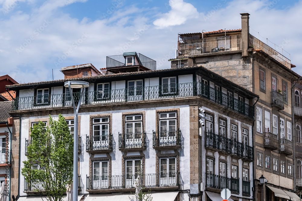 Magnificent architecture: typical colorful buildings in the center of the old town of Guimaraes. Portugal.