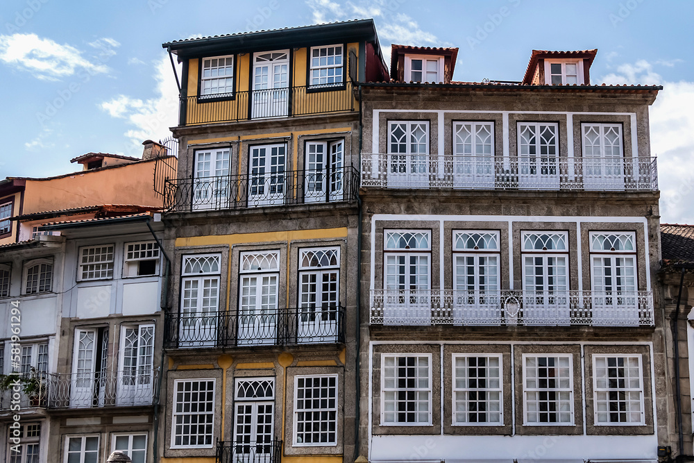 Fototapeta premium Magnificent architecture: typical colorful buildings in the center of the old town of Guimaraes. Portugal.