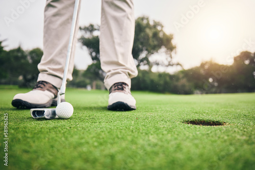 Golf, hole and player hit ball and professional athlete training and putting on a filed as exercise or workout. Sportsman, equipment and gentleman golfer or person relax and playing a sport