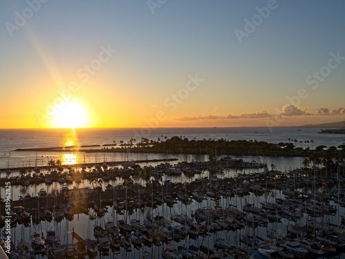 The sun sets over the Pacific Ocean, seen from Waikiki in Honolulu, Hawaii