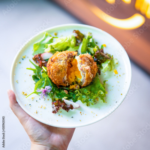 plate in the hand with food in it