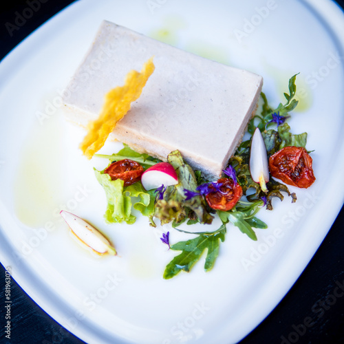 A plate of food with a piece of tofu on it