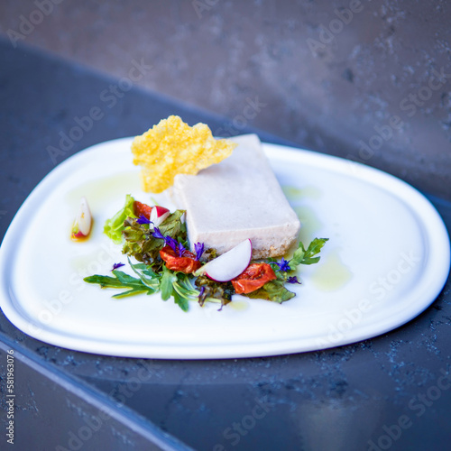 A plate of food with a piece of tofu on it