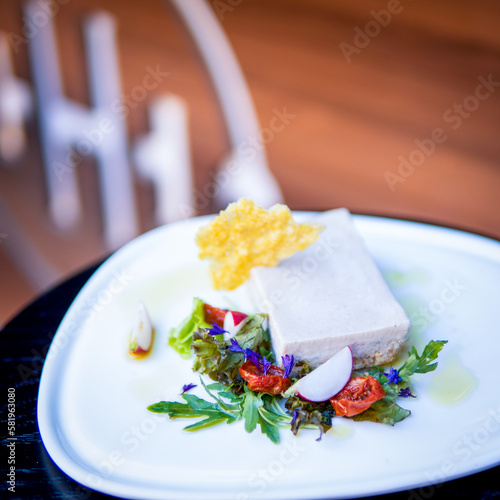 A plate of food with a piece of tofu on it