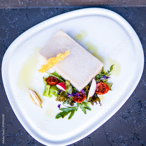 A plate of food with a piece of tofu on it