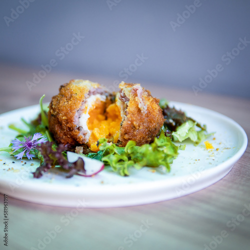 A plate of food with a fried egg on it