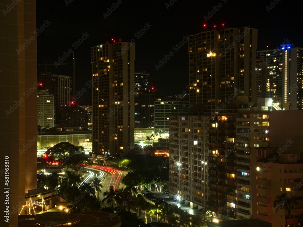 Night settles on Honolulu as the lights of the many high-rise hotels of Waikiki begin to illuminate