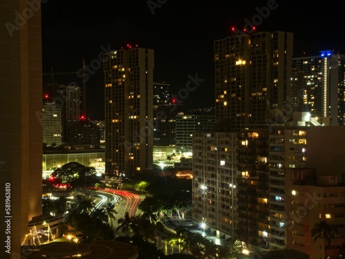 Night settles on Honolulu as the lights of the many high-rise hotels of Waikiki begin to illuminate