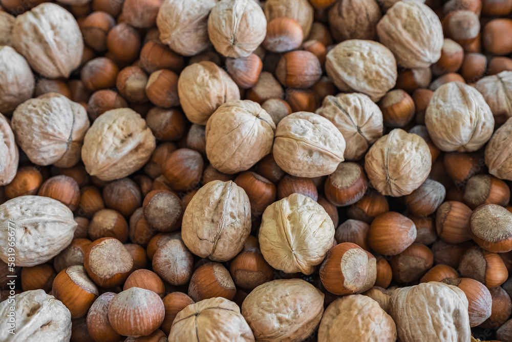 Assortment of nuts. Hazelnuts, walnuts mix for the background. Food mixed on wooden background, top view, copy space Assortment of nuts. Hazelnuts, walnuts mix for the background. Food mixed on wooden background, top view, copy space