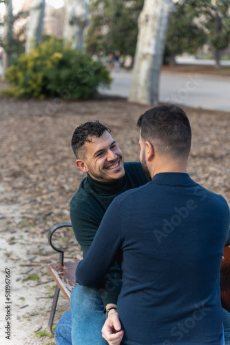 gay couple in the park, cuddling, loving and playful © Kairos