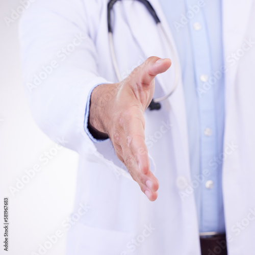Doctor, man and handshake for healthcare partnership, meeting or greeting against a white studio background. Hand of isolated male medical professional shaking hands for introduction or thank you