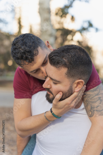 gay couple in the park  cuddling  loving and playful