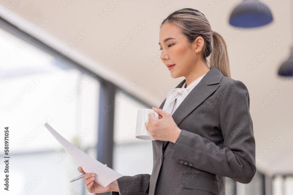 Portrait of a business Asian woman working at office reading and checking searching document tax a letter in a workplace office. Portrait of a business Asian woman working at office reading and checking searching document tax a letter in a workplace office.
