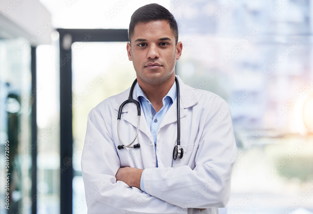 Portrait, man and doctor with arms crossed, focused and confident in hospital, clinic and surgery. Serious, proud and young medical worker in lab coat for healthcare services, wellness and commitment Portrait, man and doctor with arms crossed, focused and confident in hospital, clinic and surgery. Serious, proud and young medical worker in lab coat for healthcare services, wellness and commitment