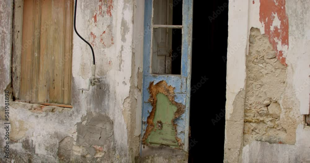 Broken window and door in poor part of the ancient seaside fishing village Nazare in Portugal. Broken window and door in poor part of the ancient seaside fishing village Nazare in Portugal.