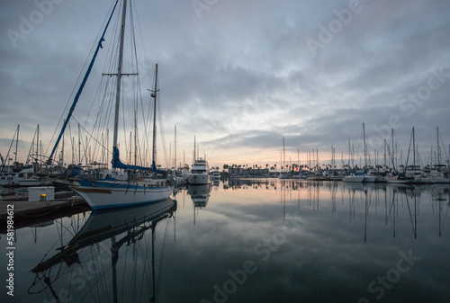 Boat and sunrise sky reflections in the Channel Islands harbor at Port Hueneme on the gold coast of California United States