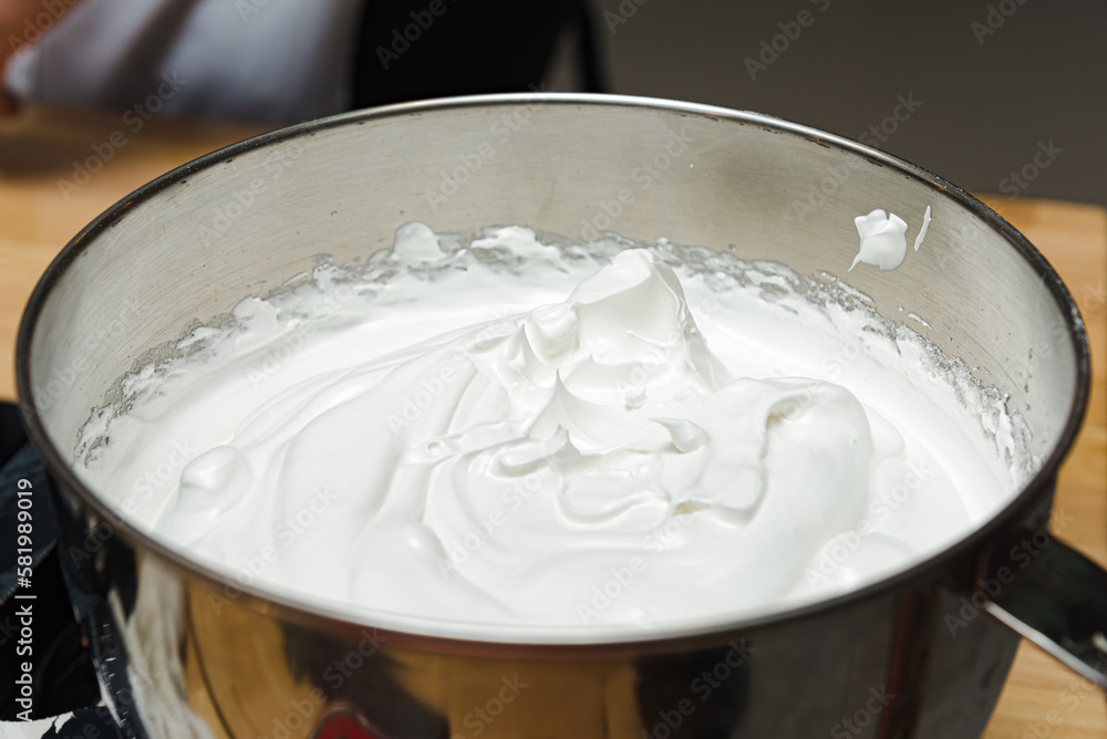 whipped cream in a deep steel bowl, close-up shot whipped cream in a deep steel bowl, close-up shot