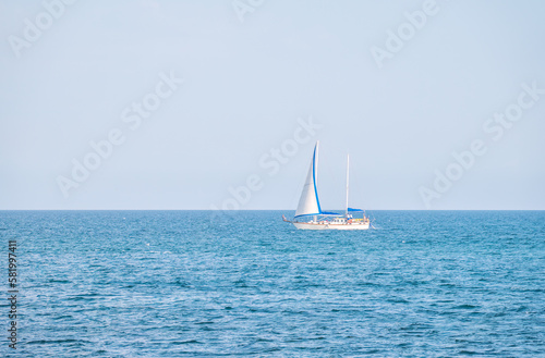 Sailing yacht in the blue calm sea. © Dmitrii Potashkin