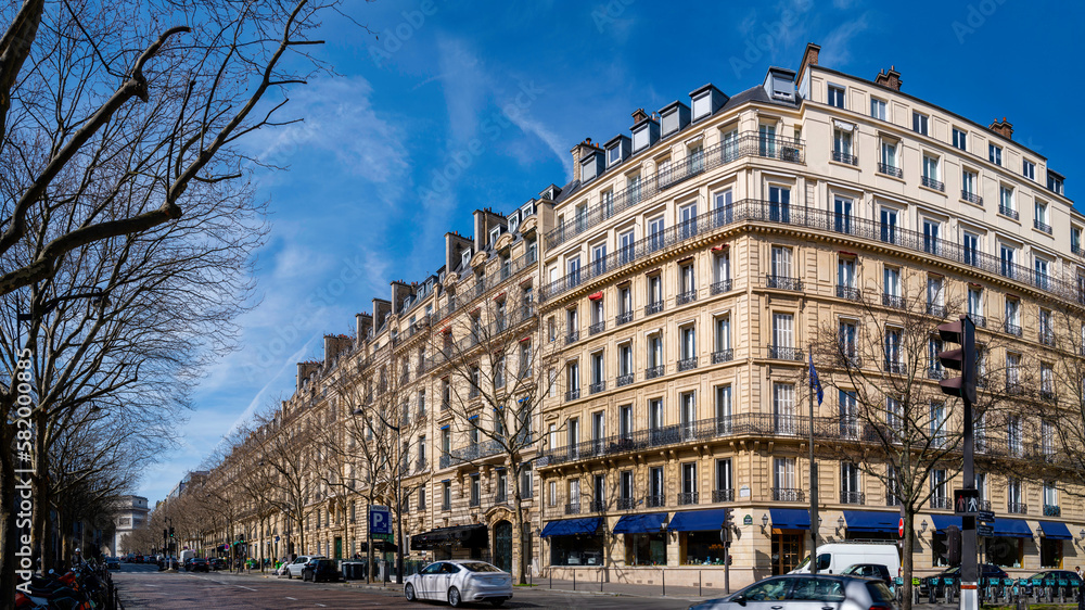 Haussmann building architectural style and street landscape in spring, Paris skyline with the blue sky and trees in France