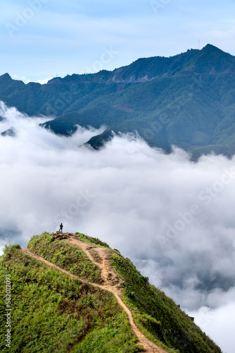 Hiking tourists explore the trail on spine and the top of the mountains Hang Dong. This is a very popular tourist destinat in Hang Dong commune, Bac Yen district, Son La Province, Vietnam  photo