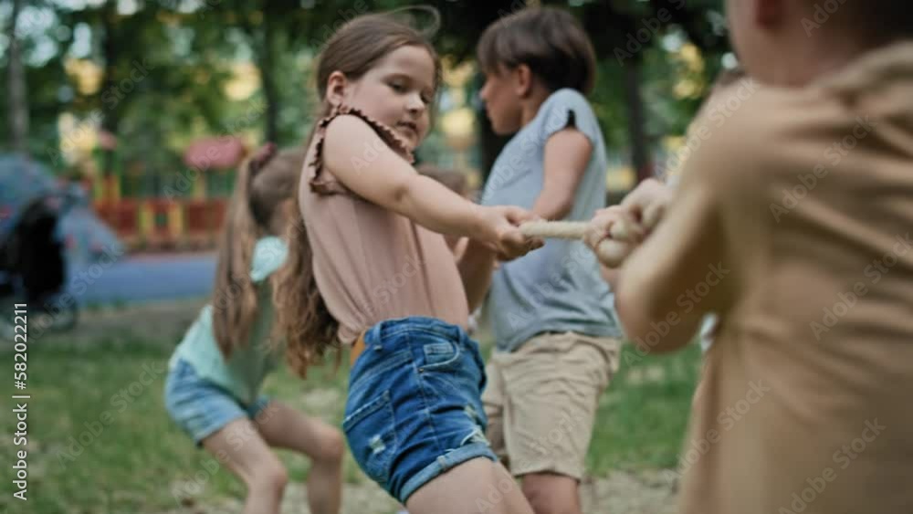 Group of caucasian kids playing tug of war. Shot with RED helium camera in 8K. Group of caucasian kids playing tug of war. Shot with RED helium camera in 8K.