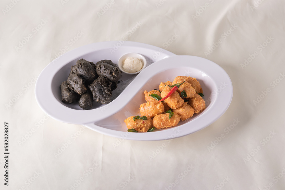 dou style deep fried crispy seafood beancurd black and white tofu in salted egg yolk sauce and mayonnaise sauce on wood table asian halal banquet appetiser snack salad menu dou style deep fried crispy seafood beancurd black and white tofu in salted egg yolk sauce and mayonnaise sauce on wood table asian halal banquet appetiser snack salad menu