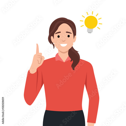 Happy business woman pointing hand up and bright light bulb appearing in the thought bubble. Idea and innovation concept