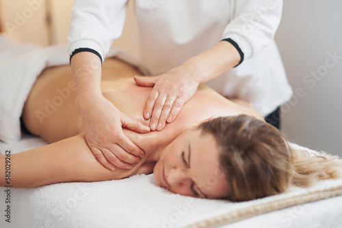 Woman having back body massage in studio