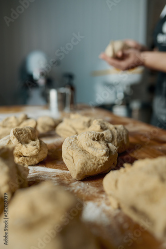 Raw cookies preparation on wooden table selective focus
