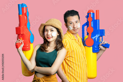 Photography Happy Asian couple playing in the water for Songkran