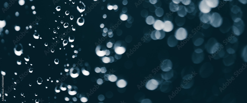 Atmospheric minimal monochrome backdrop with rain droplets on glass. Wet window with rainy drops and dirt spots closeup. Blurry minimalist background of dirty window glass with raindrops close up.