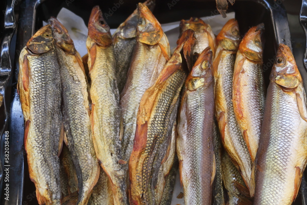 Fototapeta premium top view of dried salted pike, several fish for sale, fish delicacies, beer snacks.