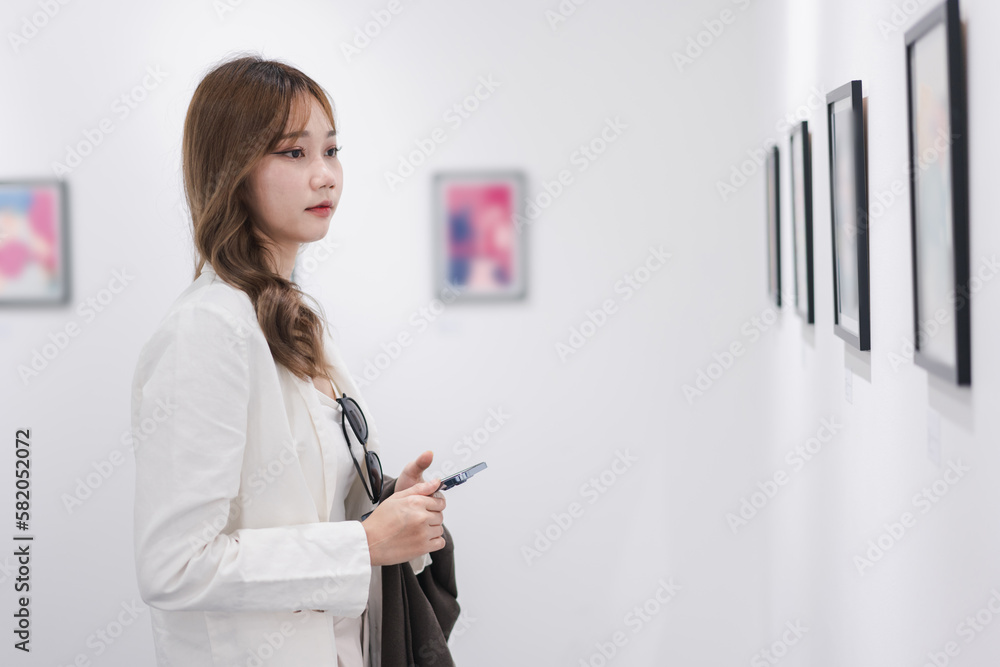 Woman visiting art gallery her looking pictures on wall watching photo frame painting at artwork museum people lifestyle concept. Woman visiting art gallery her looking pictures on wall watching photo frame painting at artwork museum people lifestyle concept.