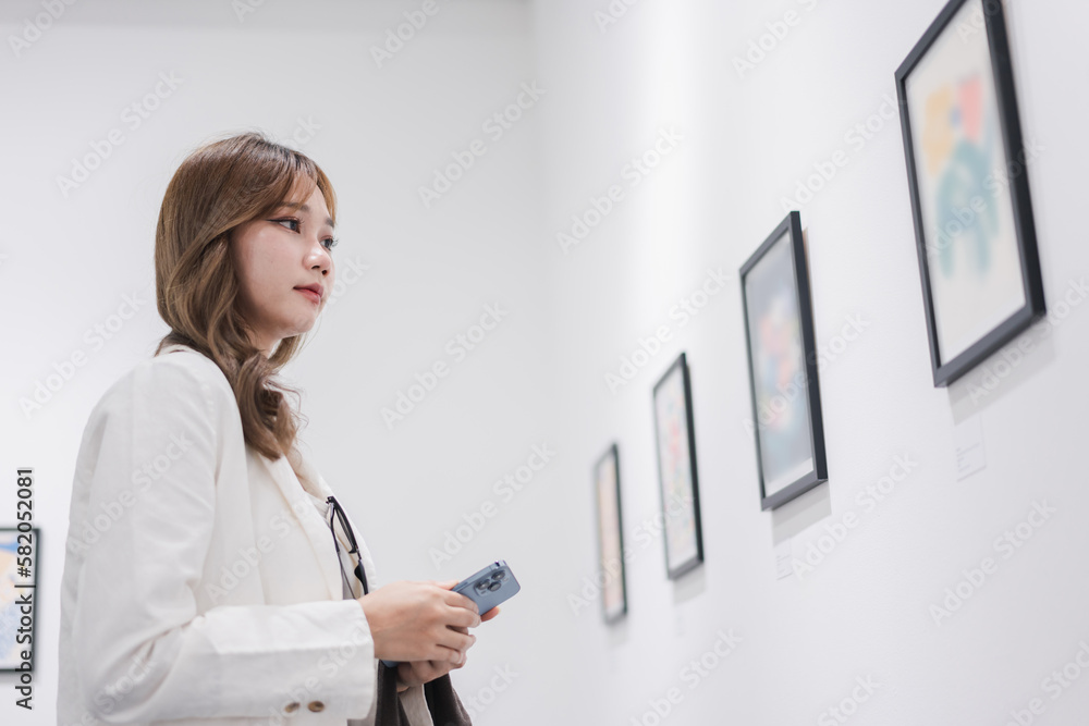 Woman visiting art gallery her looking pictures on wall watching photo frame painting at artwork museum people lifestyle concept. Woman visiting art gallery her looking pictures on wall watching photo frame painting at artwork museum people lifestyle concept.