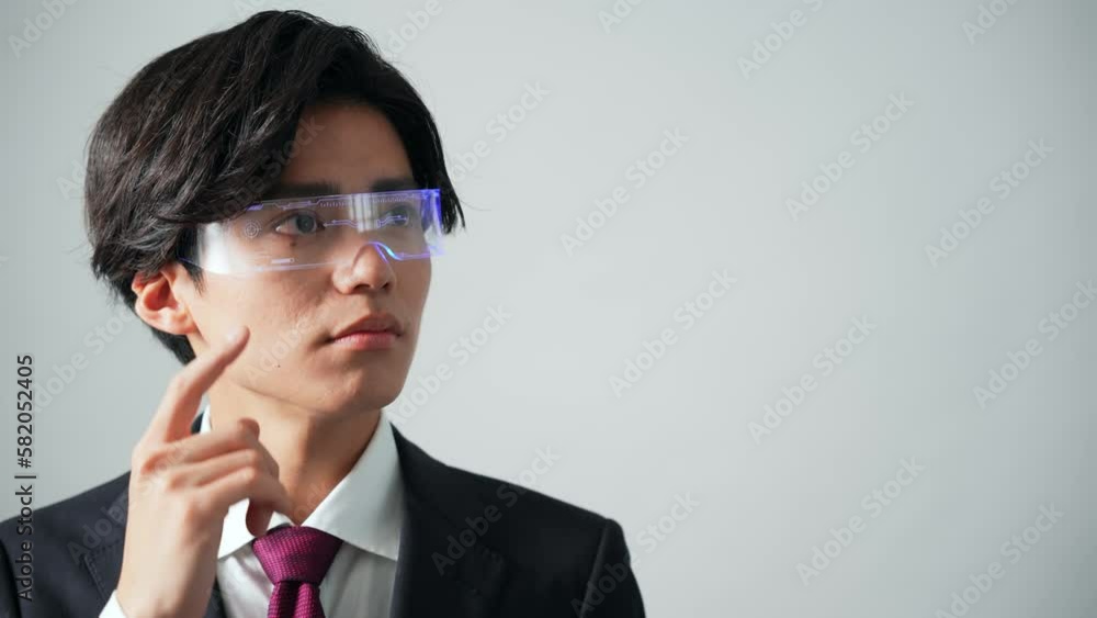 Young Asian man wearing a smart glasses. Wearable computing. Young Asian man wearing a smart glasses. Wearable computing.