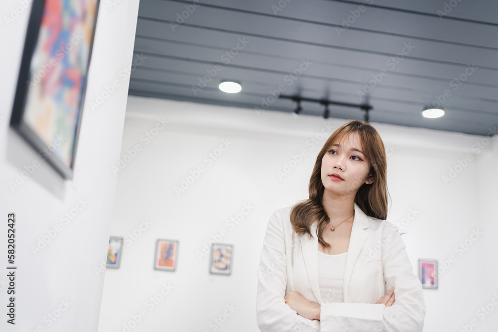 Woman visiting art gallery her looking pictures on wall watching photo frame painting at artwork museum people lifestyle concept. Woman visiting art gallery her looking pictures on wall watching photo frame painting at artwork museum people lifestyle concept.
