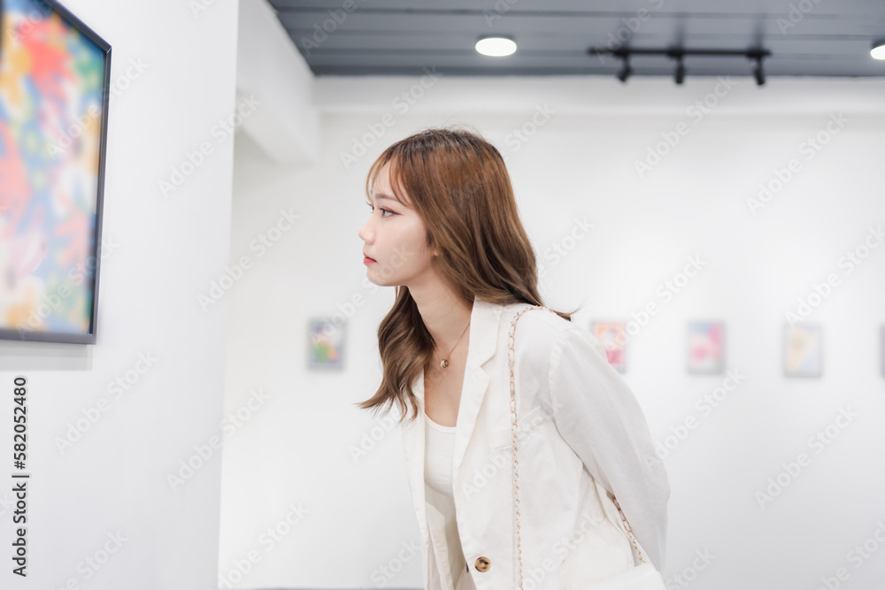 Woman visiting art gallery her looking pictures on wall watching photo frame painting at artwork museum people lifestyle concept. Woman visiting art gallery her looking pictures on wall watching photo frame painting at artwork museum people lifestyle concept.