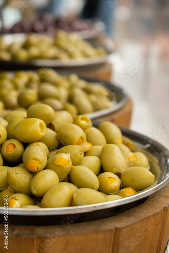 Different marinated olives and local food on street market in Gdansk, Poland. Selling and buying street food. Assortment of Appetizing olives on market. Tourist attraction