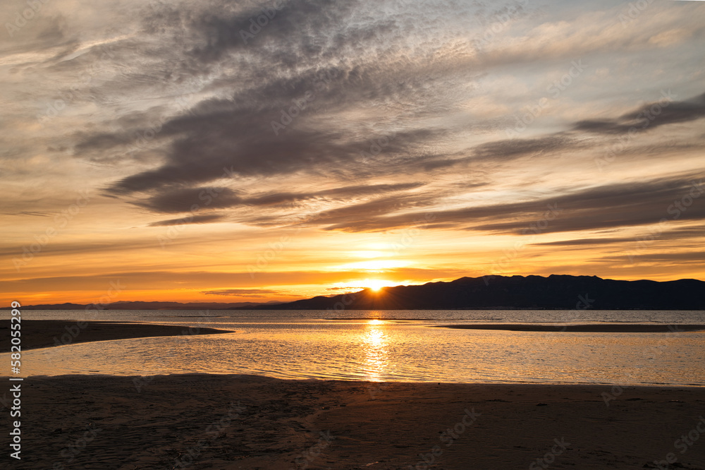 Fototapeta premium Sunset at Trabucador beach, Ebro Delta. With a warm natural light. Tarragona, Spain